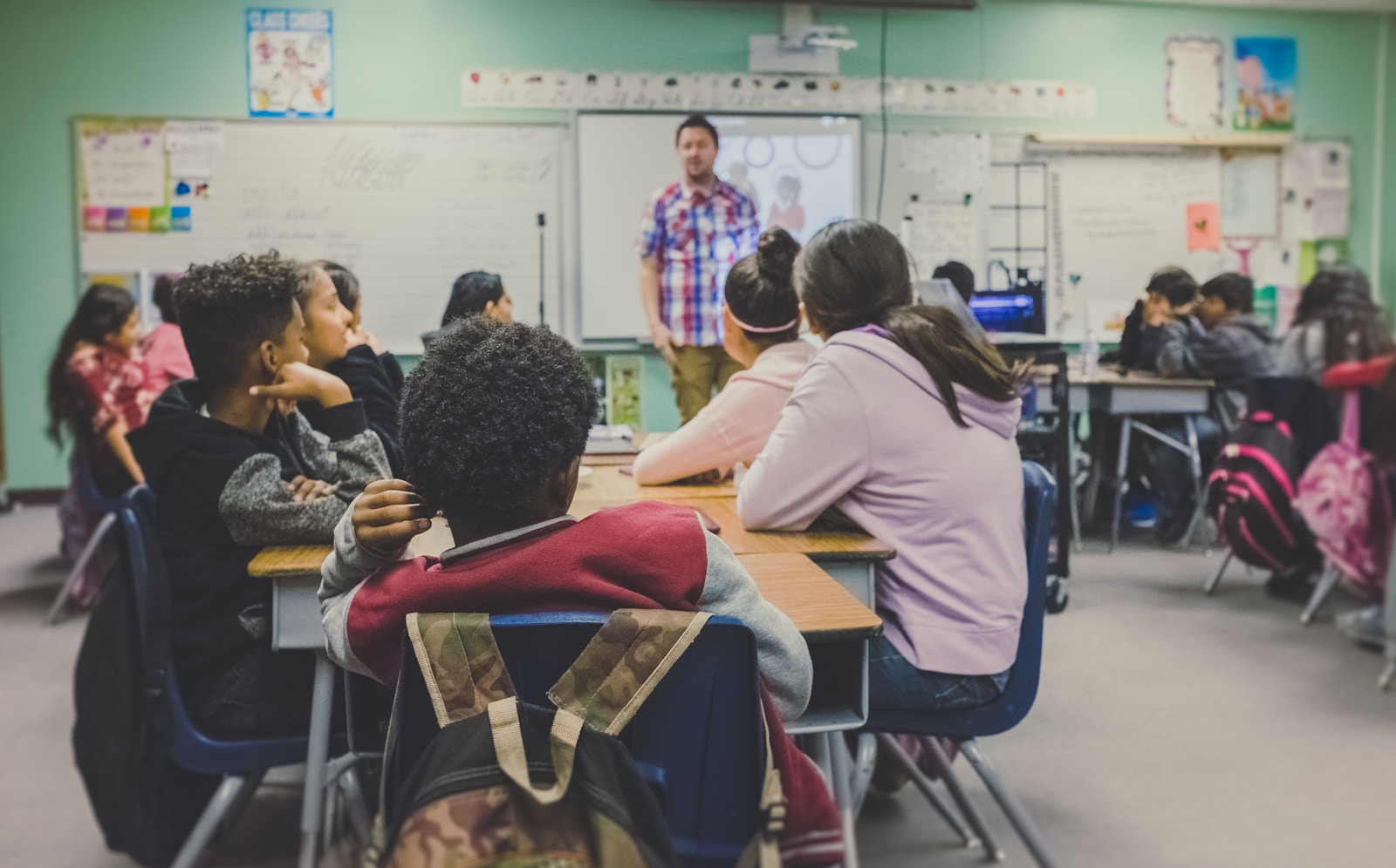 Teacher presenting a lesson to students in a classroom